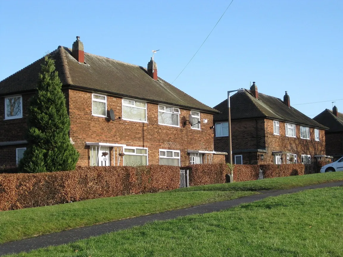 Semi-detached houses with old dark fascias and gutters